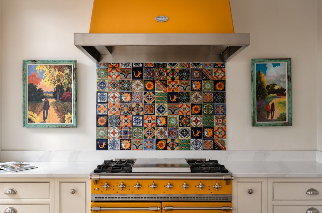 Yellow Lacanche Chagny range cooker beneath a patterned tile splashback